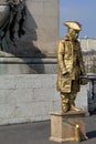 Gentleman dressed as mannequin covered in gold paint, standing on street corner, Paris, France, 2016