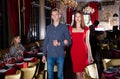 Gentleman with elegant woman walks in luxury restaurant hall Royalty Free Stock Photo