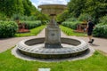 A man walking by a beautiful empty water fountain, Regent's Park, Uk