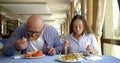 Gentleman and lady with loose hair dine in restaurant