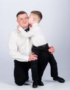 Gentleman upbringing. Father and son formal clothes outfit. Grow up gentleman. Dad and boy white shirts with bow ties Royalty Free Stock Photo