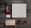 Gentlemanly set: flask for whiskey, lighter, sun glasses, notebook, pen and smoking pipe.