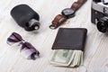 Gentlemanly set: sunglasses, perfume, wallet,camera, watch on wooden background Royalty Free Stock Photo