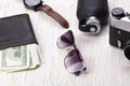 Gentlemanly set: sunglasses, perfume, wallet,camera, watch on wooden background Royalty Free Stock Photo