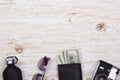 Gentlemanly set: sunglasses, perfume, wallet, money,camera on wooden background Royalty Free Stock Photo