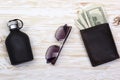 Gentlemanly set: sunglasses, perfume, wallet with money on wooden background Royalty Free Stock Photo
