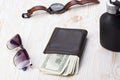 Gentlemanly set: sunglasses, perfume, wallet, watch on wooden background Royalty Free Stock Photo