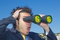 Gentlemen with binoculars looks at money and business Royalty Free Stock Photo
