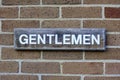 A Gentlemen sign outside a public toilet
