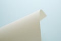 A gently curved sheet of textured paper against a soft blue background Royalty Free Stock Photo
