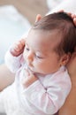 Gently mother hands holding baby . Plump and beautiful newborn Royalty Free Stock Photo