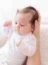 Gently mother hands holding baby . Plump and beautiful newborn Royalty Free Stock Photo