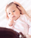 Gently mother hands holding baby . Plump and beautiful newborn Royalty Free Stock Photo