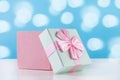 Adorable Baby Gift: Pink Present Box with Bow on White Desk