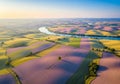 Gently rolling agricultural landscape featuring patchwork fields in shades of green and lavender. A Royalty Free Stock Photo