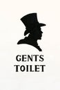 Toilet sign on white wall