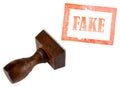Genuine fake, rubber stamp isolated on white. Business, politics or trade ethical concept. Royalty Free Stock Photo