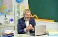 Genuinely learned man. Bearded man work on computer. Elderly man back to school. School teacher. University professor