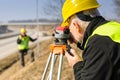 Geodesist measure land with tacheometer highway Royalty Free Stock Photo