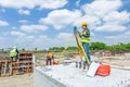 Geodesist is working with total station on a building site. Civil engineer with theodolite equipment during surveyor work. Royalty Free Stock Photo