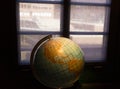 Geographic Globe in the dark room against a window