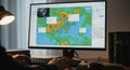 Geographic information system displaying maps and data analysis on a computer screen. Analyst uses keyboard for digital Royalty Free Stock Photo