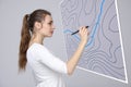 Geographic information systems concept, woman scientist working with futuristic GIS interface on a transparent screen.