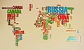 Geographic map of the world on the wall, where instead of the territory of the country its name is written Royalty Free Stock Photo