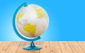 Geographical globe of Earth on the wooden table. 3D rendering