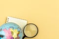 Geography and archeology flat lay background, school education and lessons concept, the globe with magnifying glass on