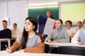 Geography lesson in school class - teacher talks about France, holding flag in his hands Royalty Free Stock Photo