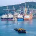 Tugboat sails pass driil ships in the Bay of Daewoo Shipbuilding and Marine Engineering DSME in Okpo city, South Korea.