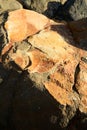 Geological formation of colorful stones with different layers, sand, fossil rocks on Magoito beach, Atlantic ocean coast near