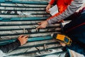 Geological gold core samples with team of mining workers measuring drilled rock top view. Selective focus Royalty Free Stock Photo