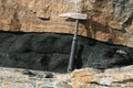 Geological hammer on the background of gneiss rock Royalty Free Stock Photo