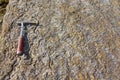 Geological hammer on the rocks Royalty Free Stock Photo