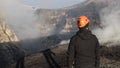 Geologist at the craters of the Etna volcano erupting