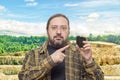 A geologist man in clean clothes with glasses holds in his hand a piece of coal Royalty Free Stock Photo