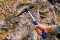 Geological hammer in hand Royalty Free Stock Photo