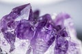 Texture of gemstone lilac Amethyst closeup as a part of cluster geode filled with rock Quartz crystals.