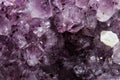 Gemstone Amethyst closeup as a part of cluster geode filled with rock Quartz crystals. Royalty Free Stock Photo