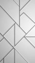 Geometric abstract pattern of interlocking white and grey triangles and quadrilaterals with sharp black outlines creating a Royalty Free Stock Photo