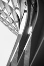 Geometric abstraction from a part of metal curved elements, parallel lines and light and shadow. Black and white vertical photo