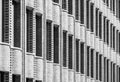 Geometric abstraction of repeating elements of the brickwork of the facade of the building with undulating ledges. Black and white