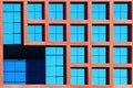 Geometric architectural background of blue and coral color. Skyscraper glass windows.