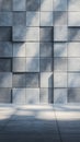 Geometric arrangement of textured concrete tiles forms a wall, each tile casting Royalty Free Stock Photo