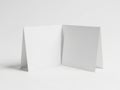 Geometric arrangement of two folded light gray paper sheets against a plain background Royalty Free Stock Photo