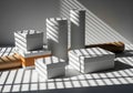 Geometric arrangement of white boxes and wooden cylinders with dramatic striped shadows on a textured surface Royalty Free Stock Photo