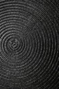 Geometric black background, circles on fabric, interweaving of threads. Minimalism. Vertical photo.