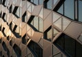 A geometric building facade featuring a tessellated pattern of hexagonal and Royalty Free Stock Photo